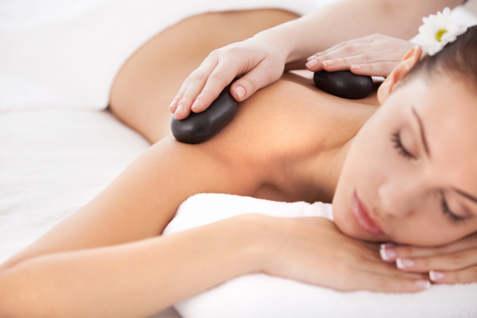 relaxing stone massage for woman with closed eyes 2026 01 08 05 30 24 utc scaled